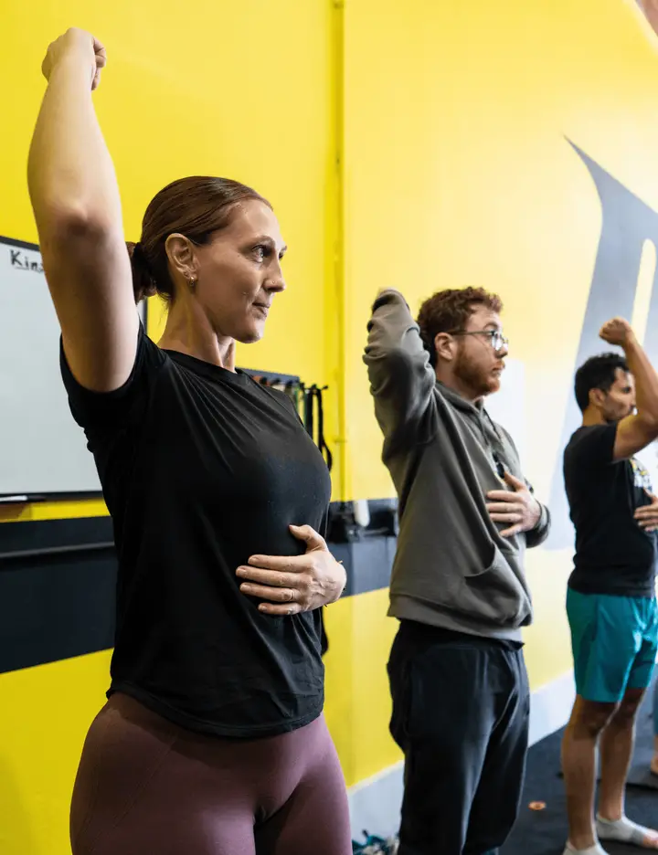 Instructor leading a group mobility class at Motive Training