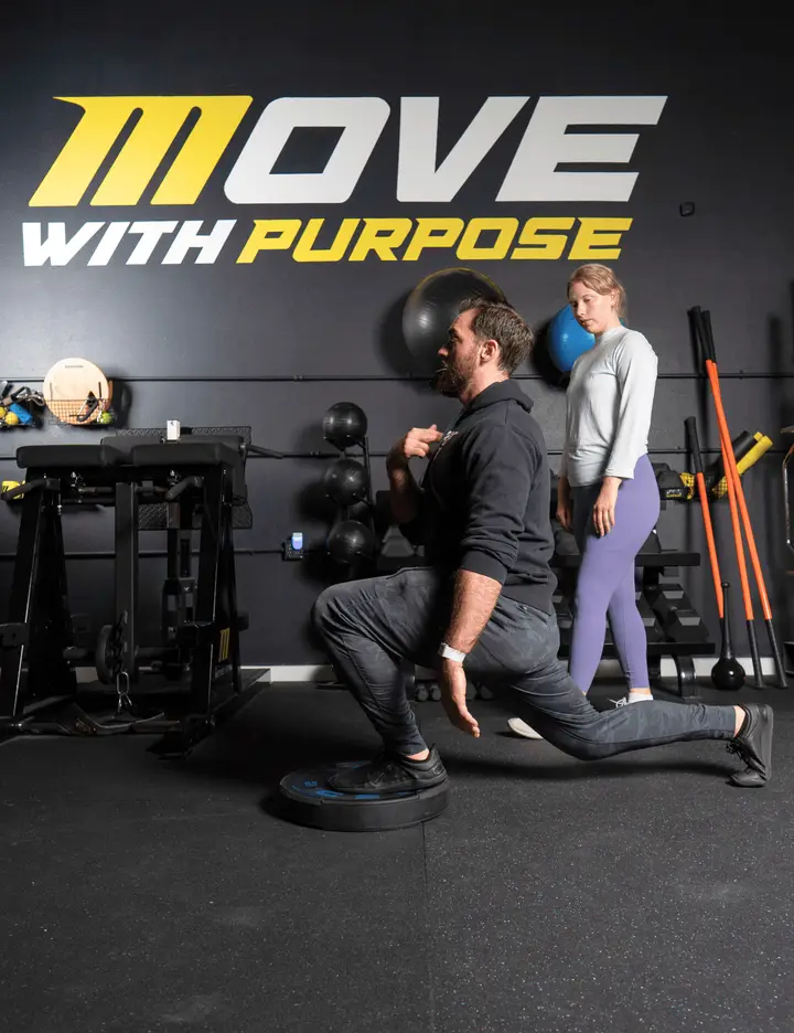 Personal trainer South Austin demonstrating mobility-focused exercises to fight pain.